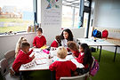 a-group-of-infant-school-kids-sitting-at-a-table-i-2024-10-19-13-03-52-utc.jpg