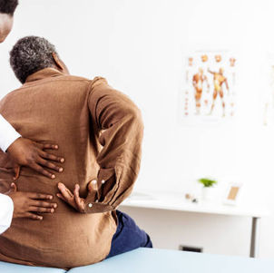 Chiropractor discussing spinal decompression candidacy with a patient at Chiropractic Works in Oak Park Michigan reviewing imaging before DRX9000 therapy.