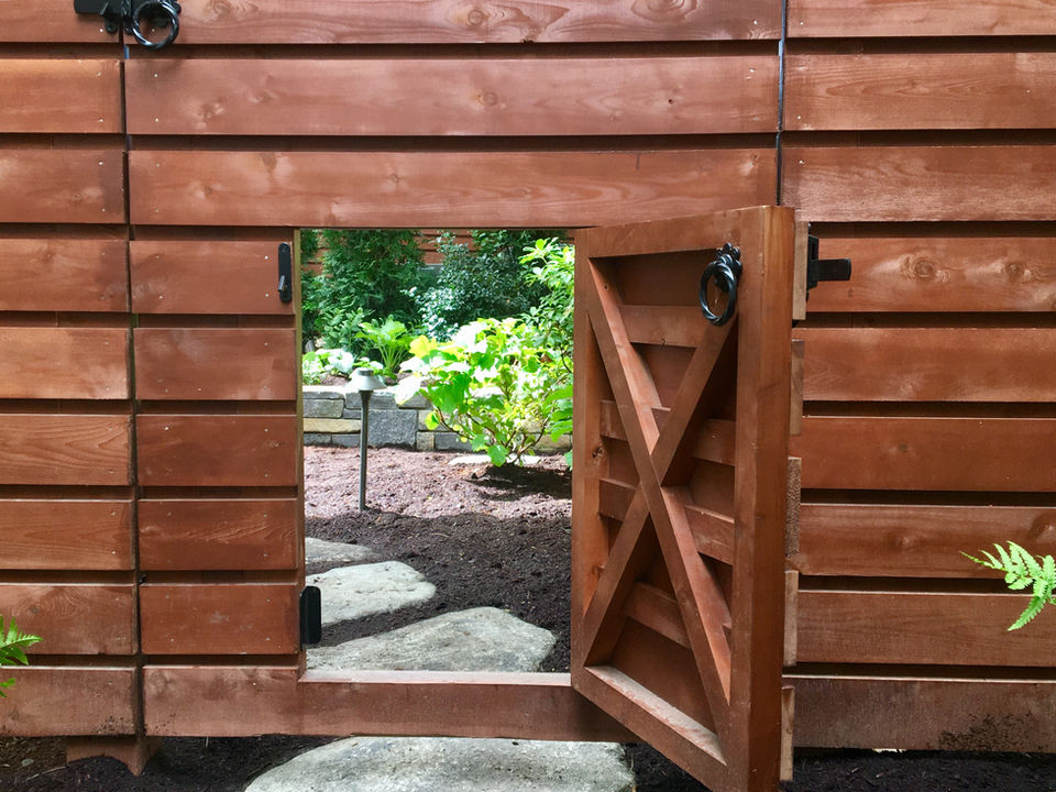 wooden door that opens up to the entrance of the backyard