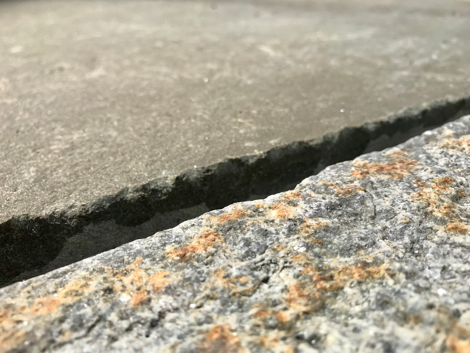 a close up view of a piece of stone pavement on the ground