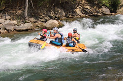 Rafting with kids and children. Family rafting in Spain in the Pyrenees.