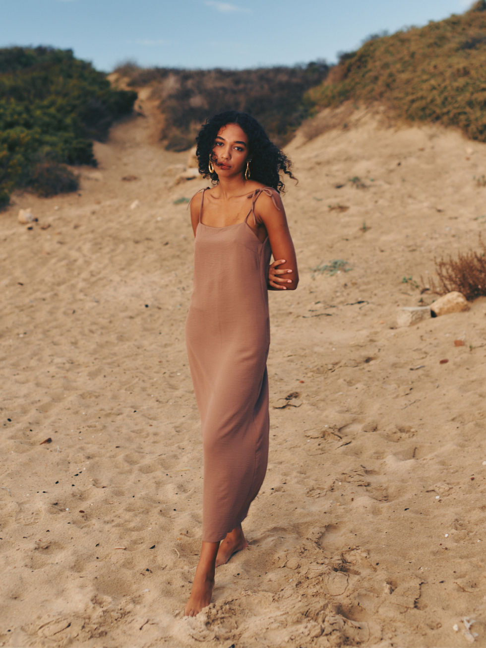 An elegant model showcasing the 'Shiraz' dress from Paloma, a brand known for its sophisticated style.