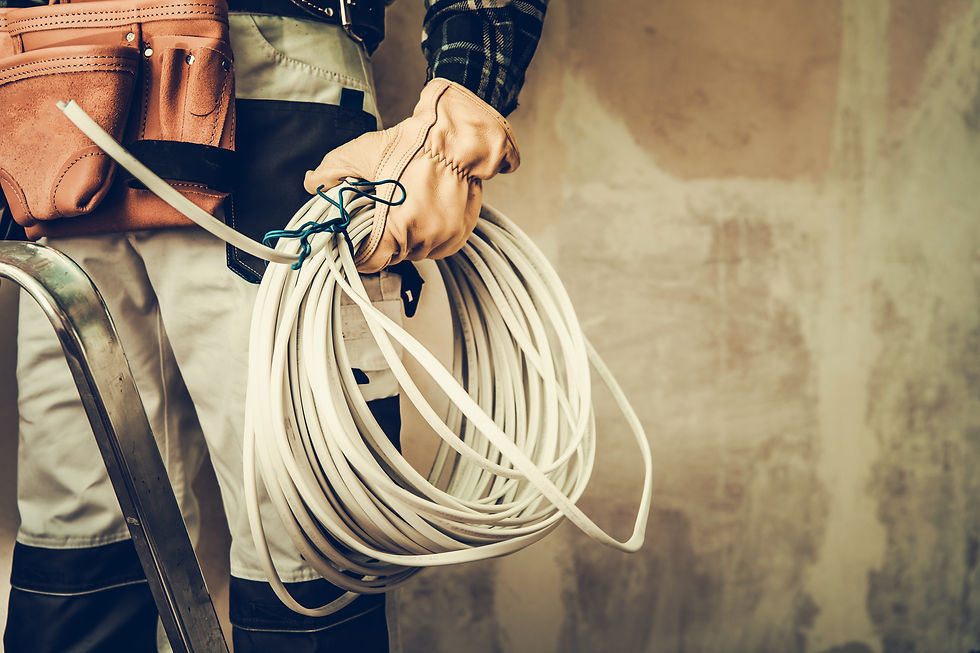Electrician Contractor with Electric Cable Closeup Photo. Installing Whole New System..jpg