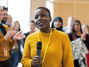 Woman speaking with confidence in a meeting at work