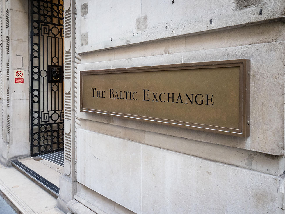 Brass sign reading “The Baltic Exchange” on a stone building exterior in London.