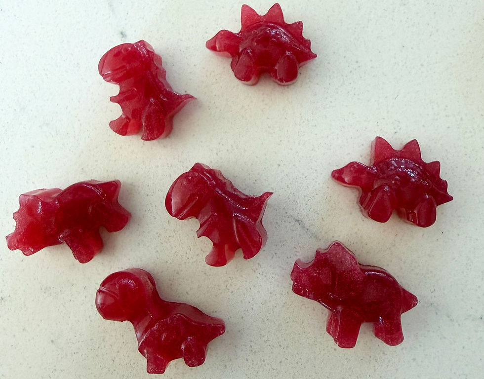 Close-up view of colorful homemade fruit snacks arranged on a wooden board