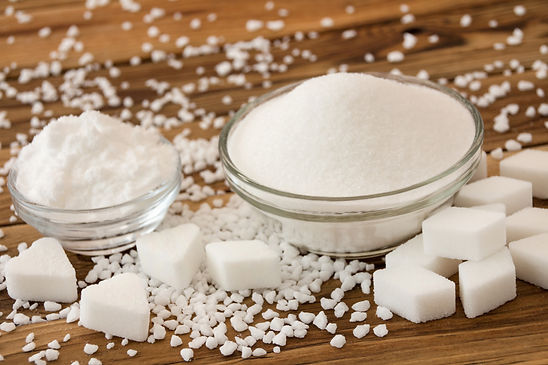 Various white sugar products on wooden background.jpg