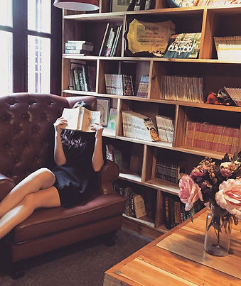 Woman on sofa reading a book
