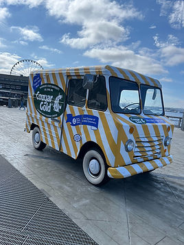 1963 Chevy step van ice cream truck with a Cougar Gold brand wrap on a pier, available for rent in Los Angeles