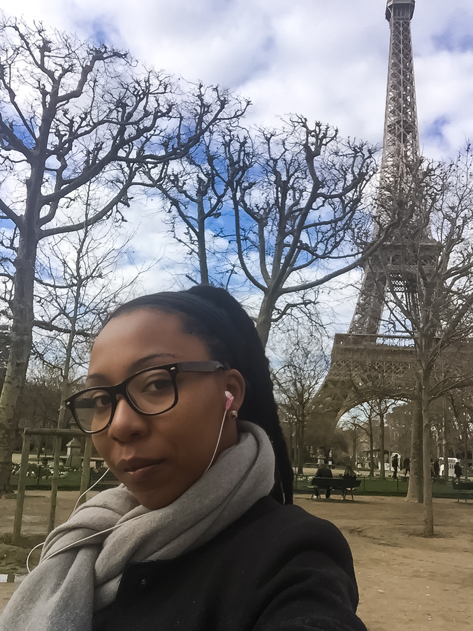 Elle standing outside with Eiffel tower in background