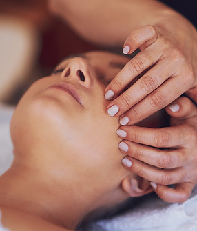Hands massaging a face