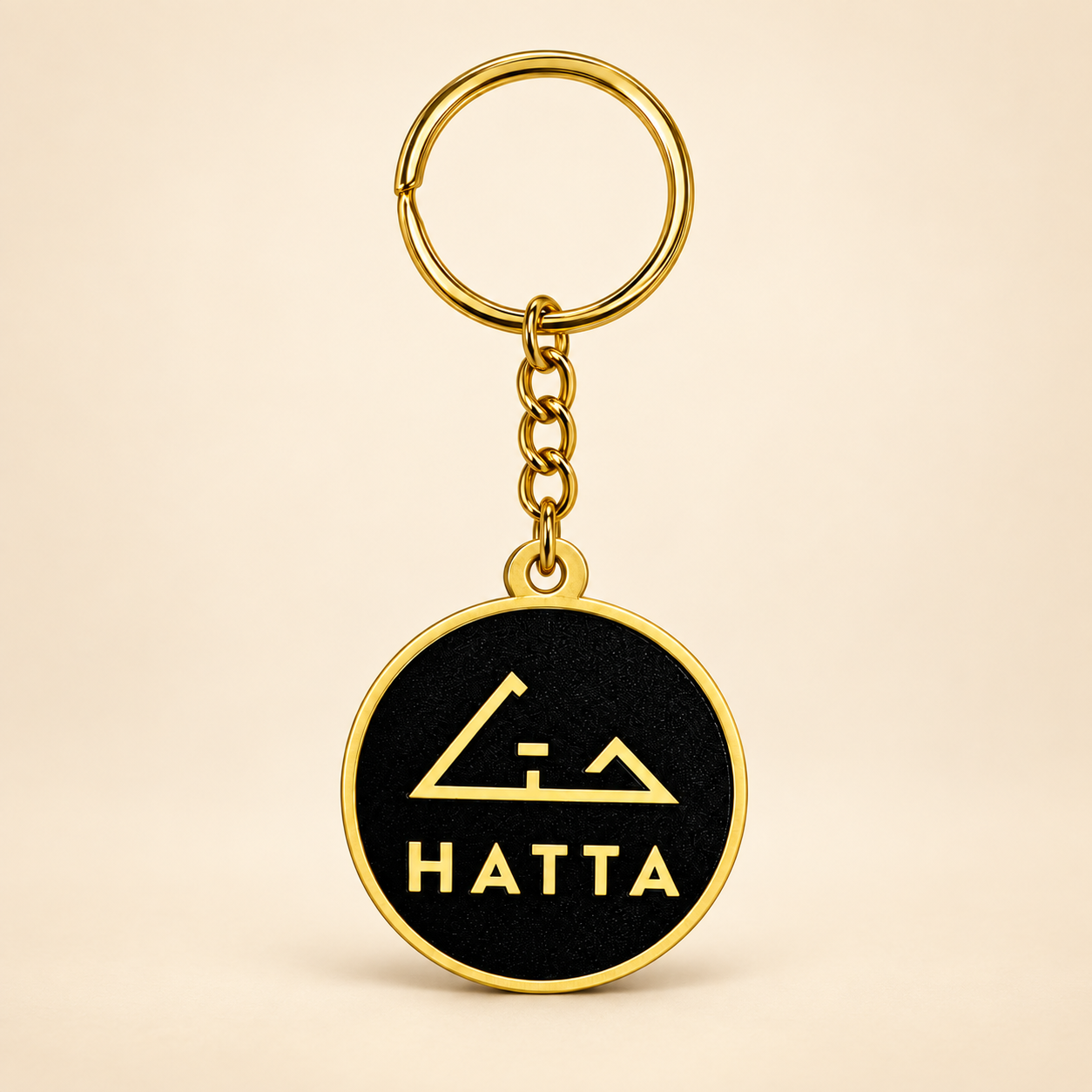 Hatta Signature Keychain with gold emblem and black logo