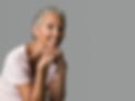 elderly-woman-smiling-gently-against-a-grey-backgr-2024-06-05-20-06-22-utc.jpg