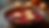 Eye-level view of floating tealight candles in a decorative bowl with flower petals