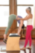 Ada supporting client on wunda chair, holding her ribs