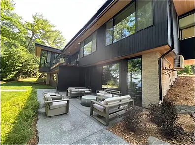 Modern luxury cottage patio with custom outdoor seating and premium hardscape design
