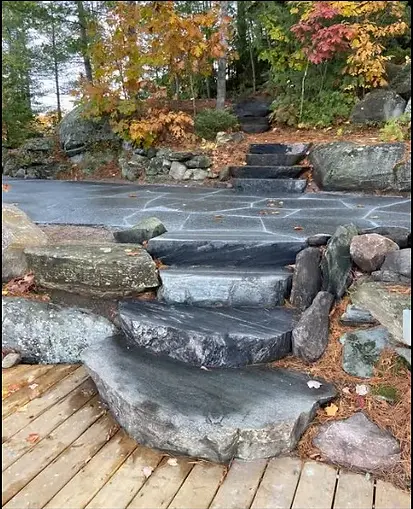 Custom granite steps and waterfront stone patio for luxury cottage landscape access