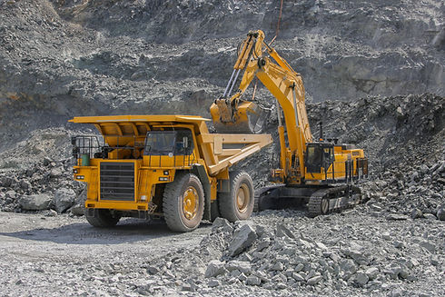 Excavator loads ore into a large mining