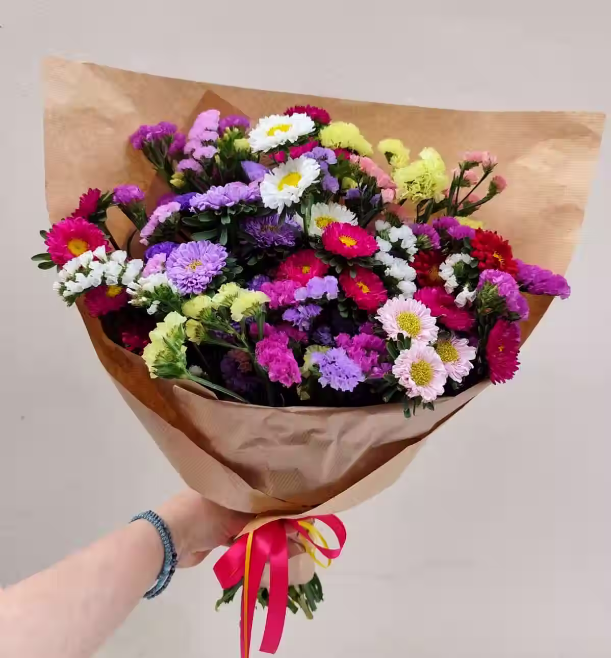 Colourful Summer Bouquet with purple, pink, and white asters and statice flowers.