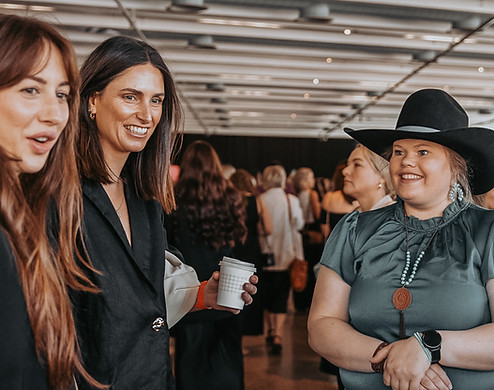 Bar M owner answering questions to happy customers abotu custom hats