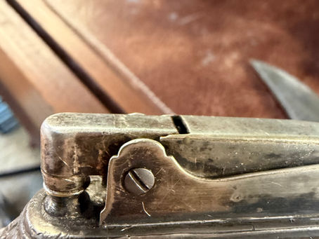 Vintage silver Queen Anne tabletop lighter burning after being cleaned and restored.