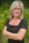 Female owner standing with arms folded