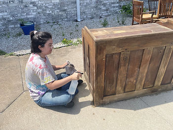 Drew Doebelin cleaning an old desk.