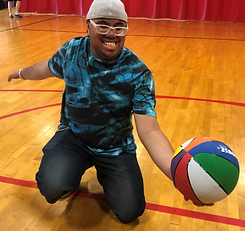 Smiling boy with glasses with basketball