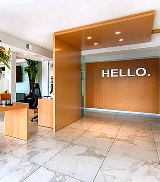 Elegant lobby with HELLO text, floral arrangement, and contemporary design elements.