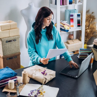 Focused woman reviewing documents at her laptop