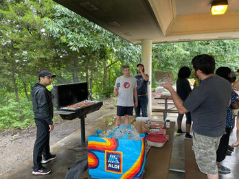 Ryan Castoro and Curtis Nutter cooking at the Neuro-Muscular Labs park picnic.