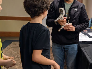 Researcher demonstrates how to measure grip strength.