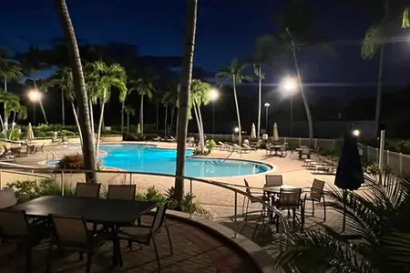 Commercial light pole installation at a resort's pool in Boca Raton, Florida.