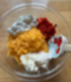 making homemade pimento cheese with cream cheese, sour cream, sharp cheddar cheese and roasted red peppers