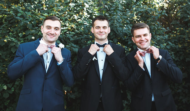 three-men-suits-posing-garden.jpg