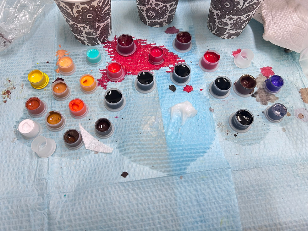 Close-up view of a tattoo artist preparing ink and needles for a session