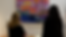 Two people looking at a piece of artwork