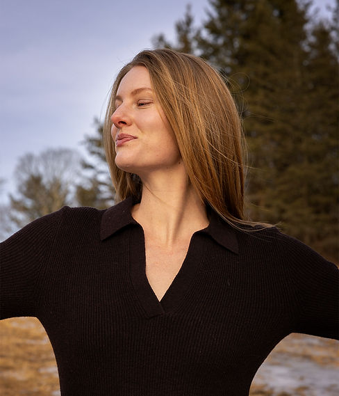 women smiling with arms out looking peaceful