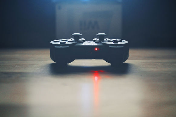 Black PS4 controller with laser light popping out from the middle