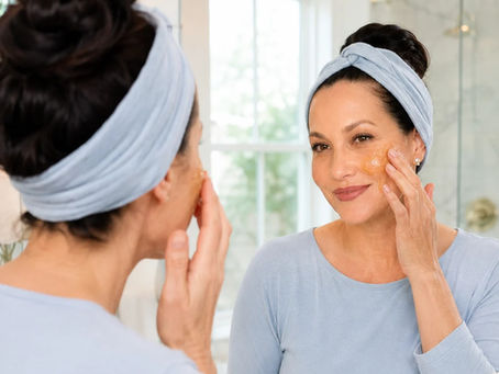 Woman applying a raw honey face mask in a bright bathroom as part of a natural skincare ritual from From Kitchen to Bedroom.