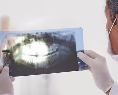 Dentist holding X-ray