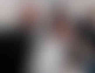 a man and woman holding a framed certificate and glass award trophy