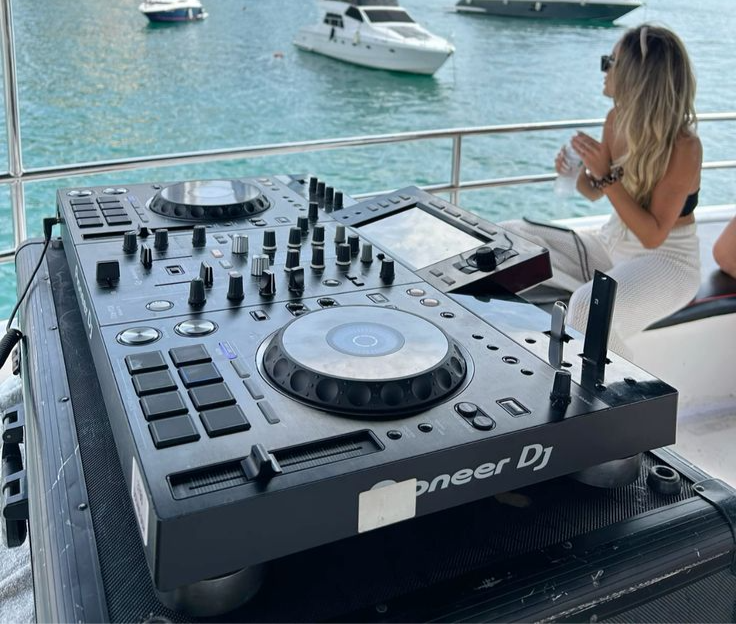 DJ setup on a yacht in Miami with professional equipment creating a party vibe during a boat rental experience