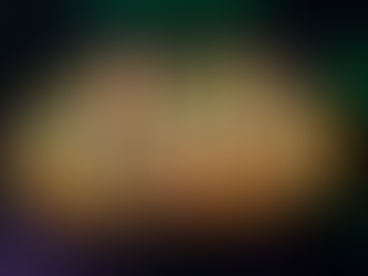 Loaded nachos topped with cheese, sour cream, black beans, and green onions on a dark plate. The background has a green and purple pattern.