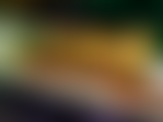 Bone marrow dish with meat, mustard seeds, and herbs on a white plate. Served with crackers. Green backdrop with a Halloween theme.