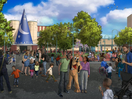 People enjoying a lively day at a theme park plaza, posing with a costumed character. Blue hat on building reads "ANIMATION." Trees in background. The reimagined Animation Courtyard will be coming to Hollywood Studios in 2026.