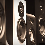 black and gray speakers on brown wooden