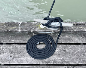 perfectly knotted rope of a moored boat on our slip