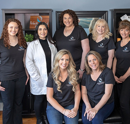 A group photo of the practitioners at Perfectly Kneaded.