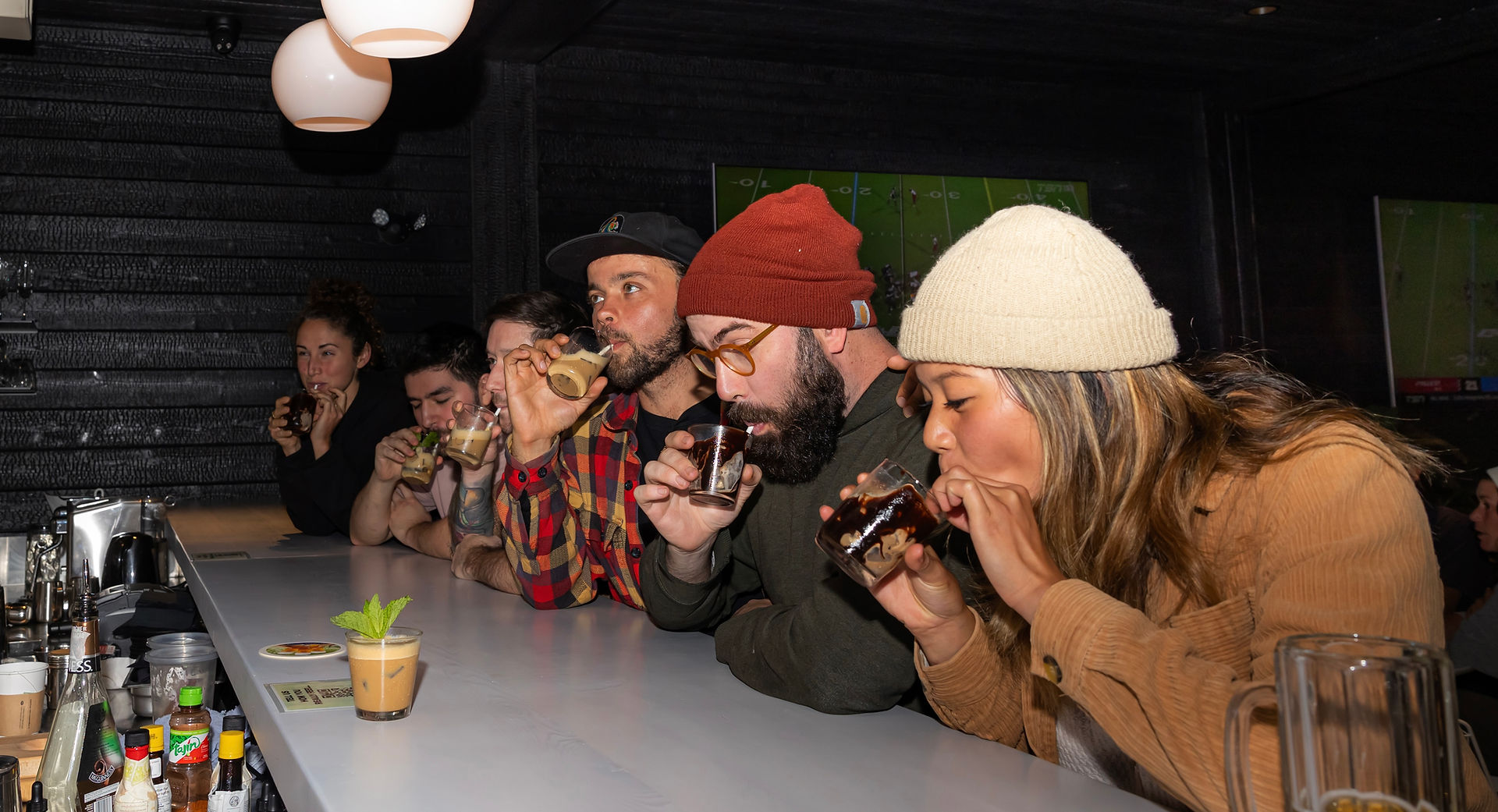 group of friends sharing food and drinks at The Bear Bierhaus Tofino